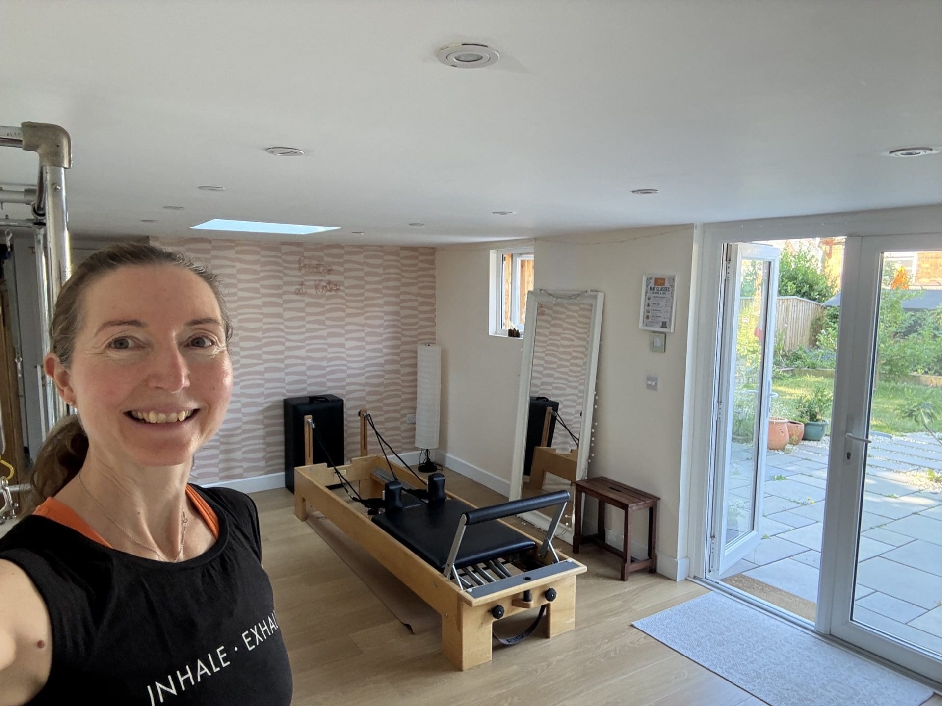 Lucy Purrier in the Broadstone studio beside the Pilates Reformer.